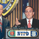 New York mayor Rudolph Giuliani, flanked by police commissioner
Howard Safir, fields reporters' questions about the accidental killing of
a Jamaican immigrant by 27 NYPD officers.